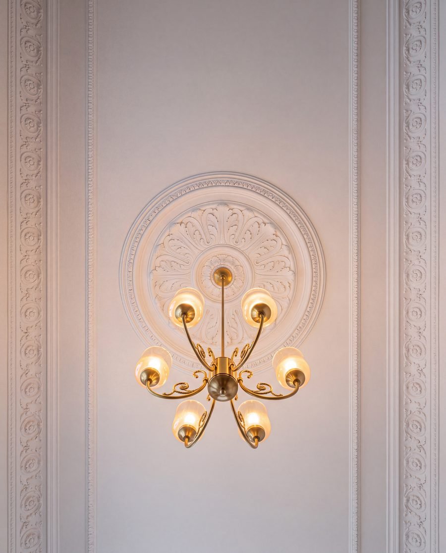Restored ceiling rosette and brass chandelier